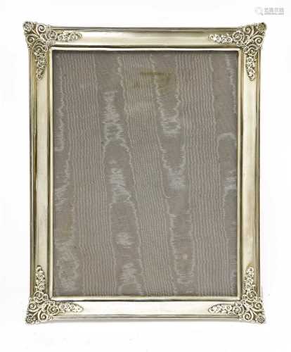 A silver photograph frame and easel stand,