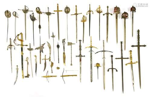 A collection of thirty-two miniature swords,