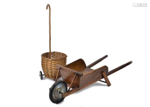 A vintage child's wicker shopping basket on wheels, together with a child's wooden wheelbarrow (2)