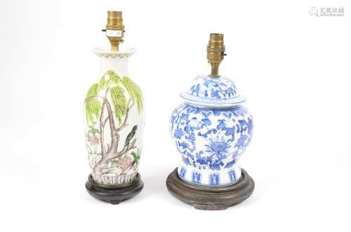Two modern Chinese porcelain lamp bases, decorated with flowers, on wooden stands, no shades, 30