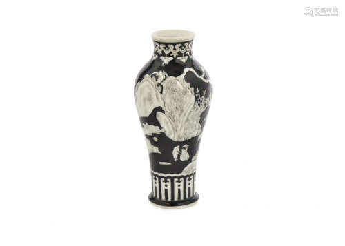 A late 19th Century Chinese black and white porcelain baluster vase, decorated with figures in a