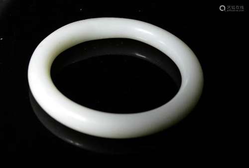 A Chinese pale green jade bangle.