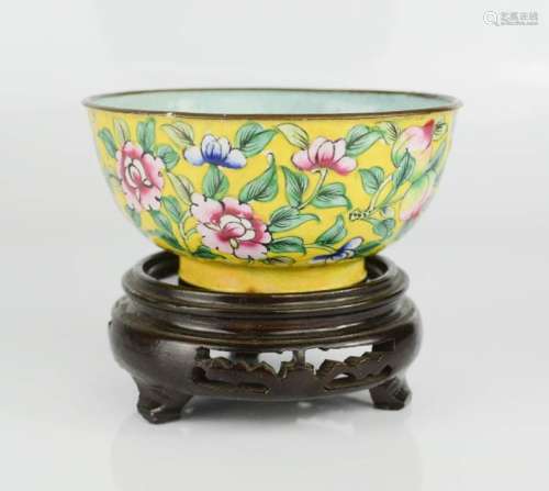 A late 19th century Chinese enamelled hand decorated Famille Rose copper bowl on laquered wooden