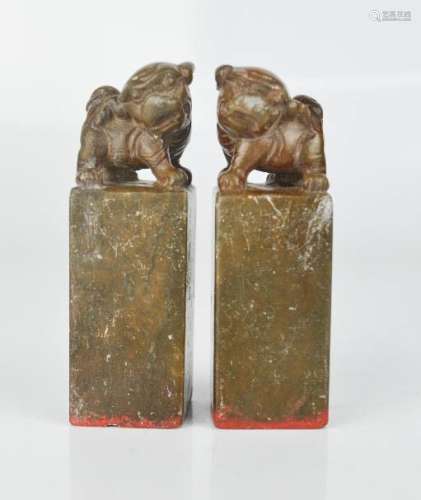 A pair of Chinese soapstone seals, carved with dogs of fo.
