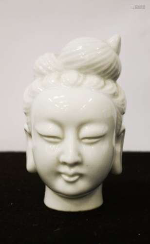 A blanc de chine ceramic Buddha head, 13cm high.