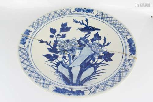 A Chinese blue and white charger, blue and white depicting a bird and flowers.