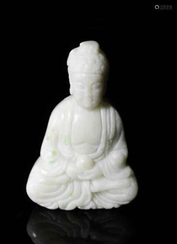 A Chinese hand carved white jade seated Buddha.