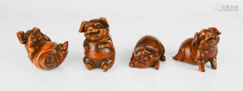 Four Chinese hand carved boxwood figures of 'happy pigs'.