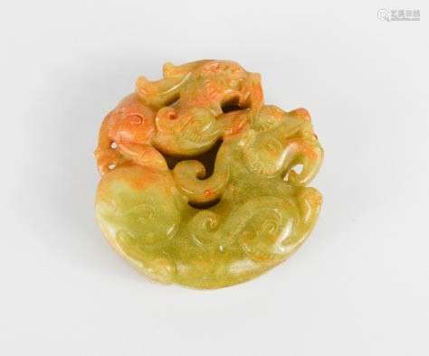 A Chinese carved nephrite jade pendant of two Kylin dogs of fo.