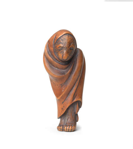 Edo period (1615-1868), early-mid 19th century A large wood netsuke of a standing tanuki bozu