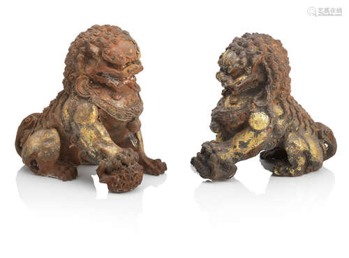 A pair of gilt-decorated cast-iron Buddhist lions