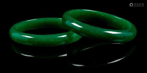 A Pair of Chinese Green Jade Bangles each of