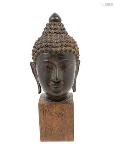 A Thai Bronze Head of Buddha with tight curled hair,