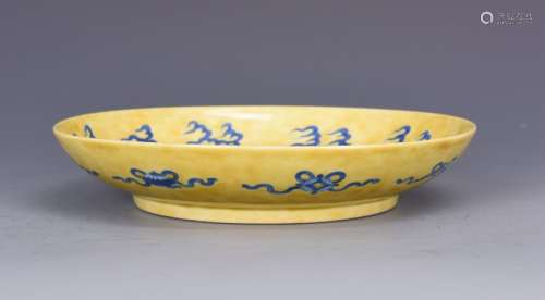 A CHINESE BLUE DECORATED YELLOW GROUND DISH, KANGXI