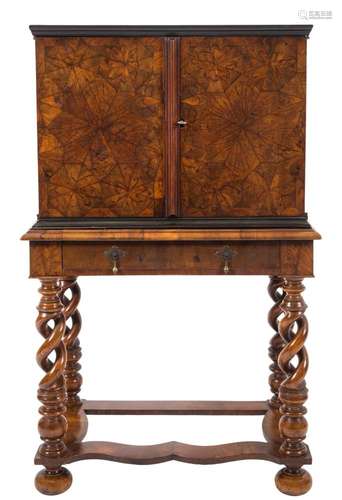 An early 18th Century walnut oyster veneer and parquetry cabinet on a later stand:,