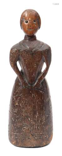 An early 18th century carved wood figure of a lady: wearing a long dress,