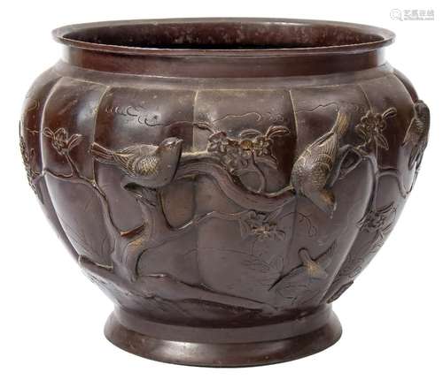 A Japanese bronze jardiniere: of circular lobed form decorated in low relief with birds amongst