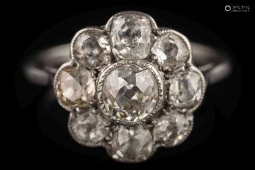 A diamond mounted circular cluster ring: with central round old brilliant-cut diamond approximately