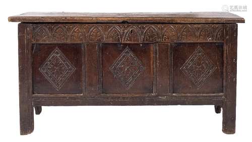 An 18th Century carved oak rectangular coffer:, with a plain hinged moulded top,