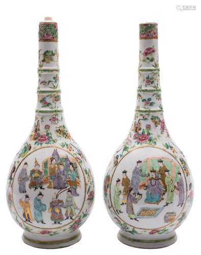 A pair of Canton famille rose bottle vases: with triple ring necks,