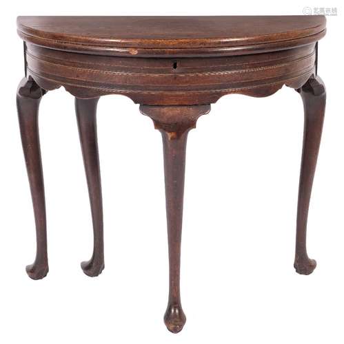 A mid 18th Century mahogany half round tea table:, the hinged top enclosing a well,