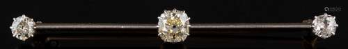 A diamond three-stone bar brooch: the central cushion-shaped old,