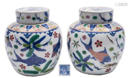 A pair of Chinese wucai jars and covers: painted overall with fish and crustacae swimming amongst