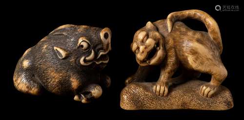 A Japanese ivory netsuke of a wild boar and an okimono of a shishi: the first with ebony eyes,