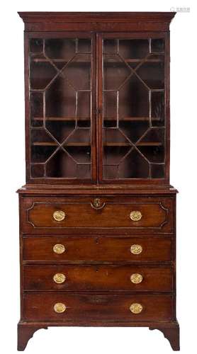 An early 19th Century mahogany secretaire bookcase:, the upper part with a moulded cornice,