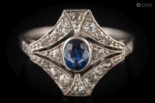 An Art Deco sapphire and diamond cluster ring: the central, oval sapphire approximately 5.