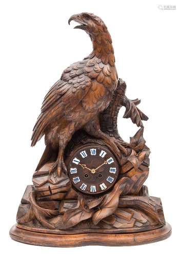 A Black Forest carved lindenwood mantel clock: having a French eight-day duration movement striking