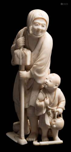 A Japanese carved ivory okimono: of a peasant farmer and his son, holding a hoe in one hand,