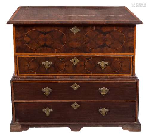 A walnut oyster veneered banded and inlaid chest in the William and Mary taste:, on a later base,