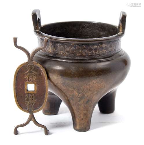 A small Chinese bronze tripod censer: key-pattern neck and handles, golden brown patination,