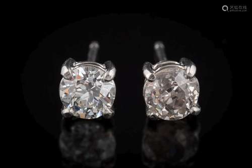 A pair of platinum and diamond single-stone ear-studs: each with a round old brilliant-cut diamond