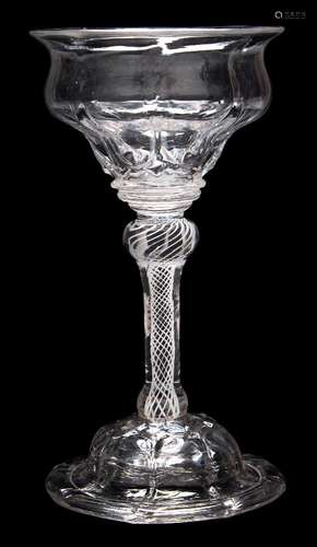 A sweetmeat glass: the panel moulded double ogee bowl with everted rim and basal diamond studs set