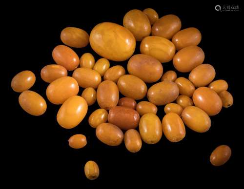 A collection of 43 amber beads: ranging 12mm long x 9mm wide, to 32mm long x 25mm wide,