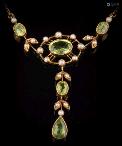 An Edwardian peridot and seed pearl lavalier: the central, oval peridot approximately 9mm long x 6.