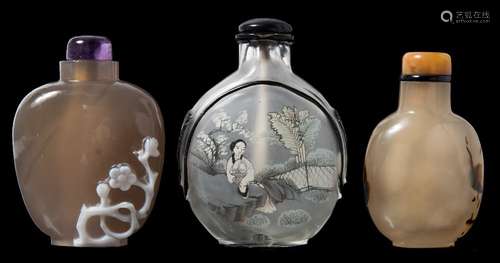 A group of three Chinese snuff bottles and stoppers: comprising an interior decorated glass bottle,