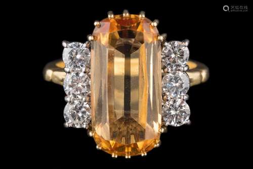 An imperial topaz and diamond cluster ring: with central oblong topaz approximately 17mm long x 8.