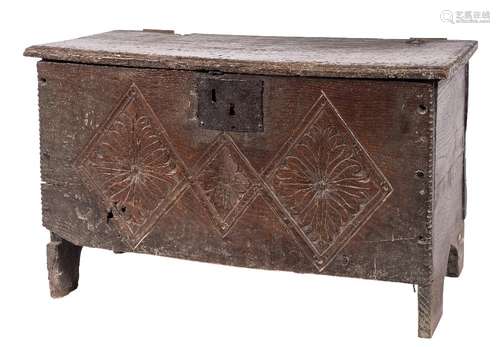 An early 18th Century oak plank coffer:, of small size, with a plain hinged moulded top,