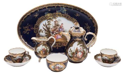 A Meissen blue ground cabaret set: painted with shaped panels of figures in romantic landscape