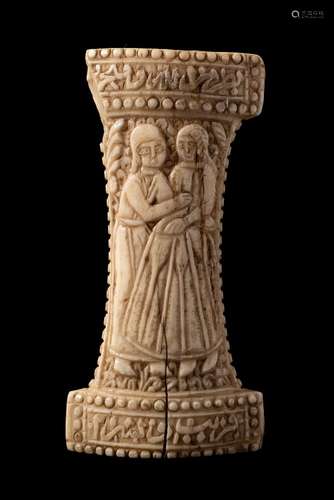 A Qajar walrus ivory Jambiya hilt: each side panel carved with a couple wearing European dress