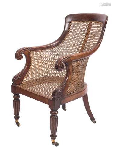 A Regency mahogany bergere armchair:, the curved cane panel back with plain top rail,