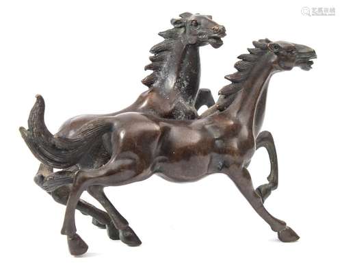 A Chinese bronze group of two horses: cantering side by side, unsigned, 17cm. long.