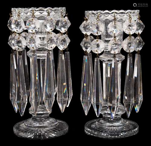 A pair of cut glass table lustres: with circular star cut bases supporting an octagonal column and