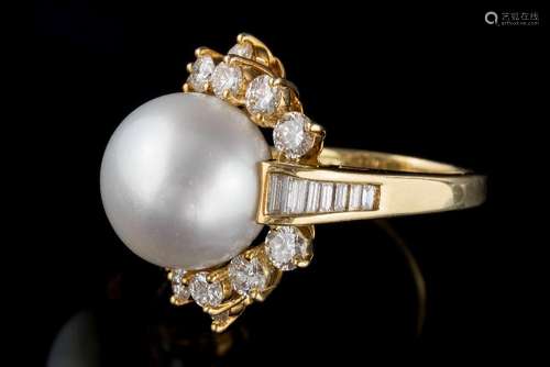 A large cultured pearl and diamond cluster ring: with central cultured pearl 14mm diameter within a