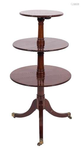 A Regency mahogany circular three tier graduated dumb waiter:, the hinged tops with moulded edges,