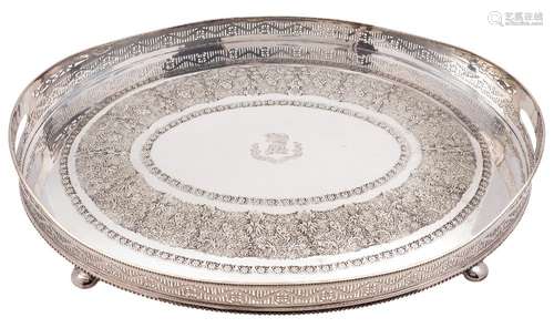 A large oval galleried tea tray: the crest enclosed by banded foliate borders,