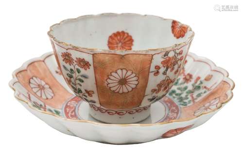 A Chinese famille verte fluted teabowl and saucer: painted with alternating panels of flowers and